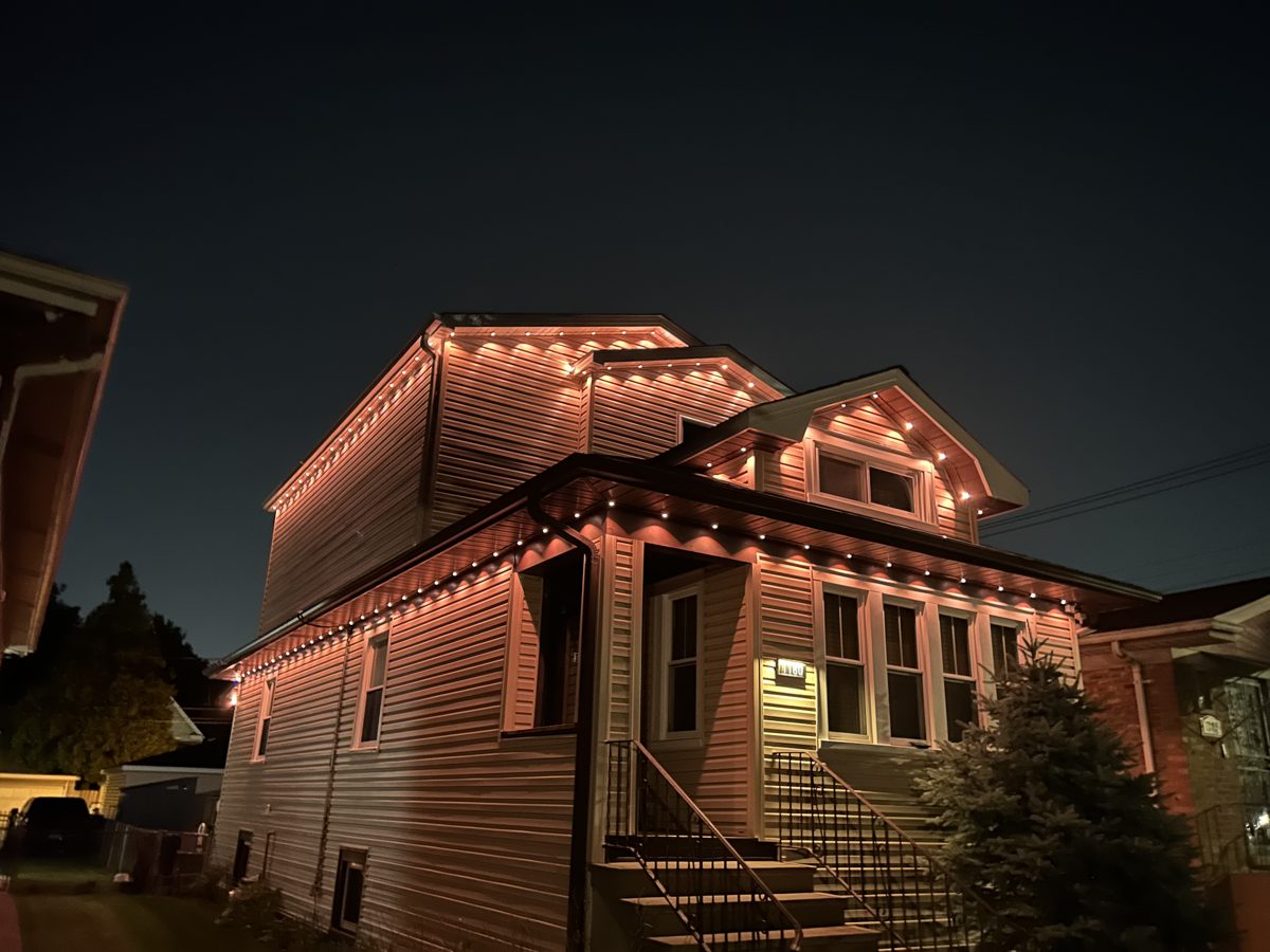 Home with warm-white permanent architectural lighting at night